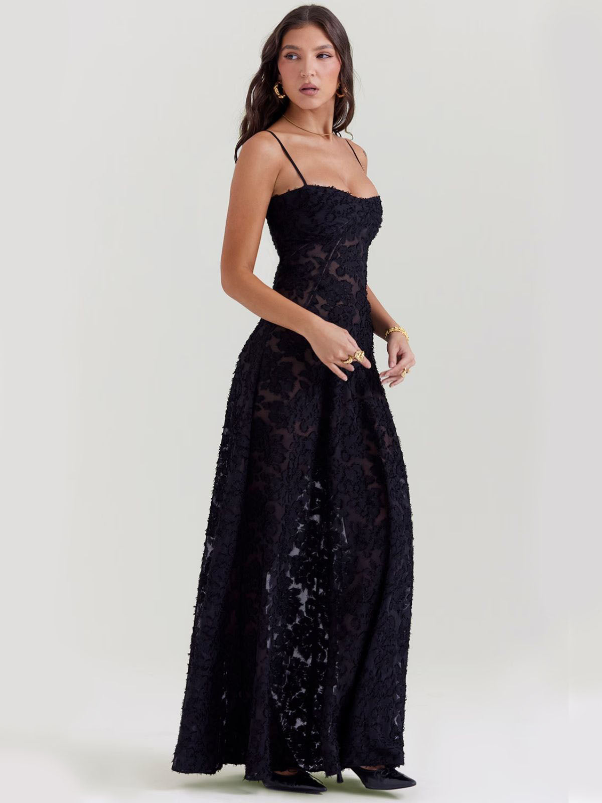 Elegant black floral maxi dress with sheer floral embroidery, slim straps, and a graceful maxi-length flowy skirt.