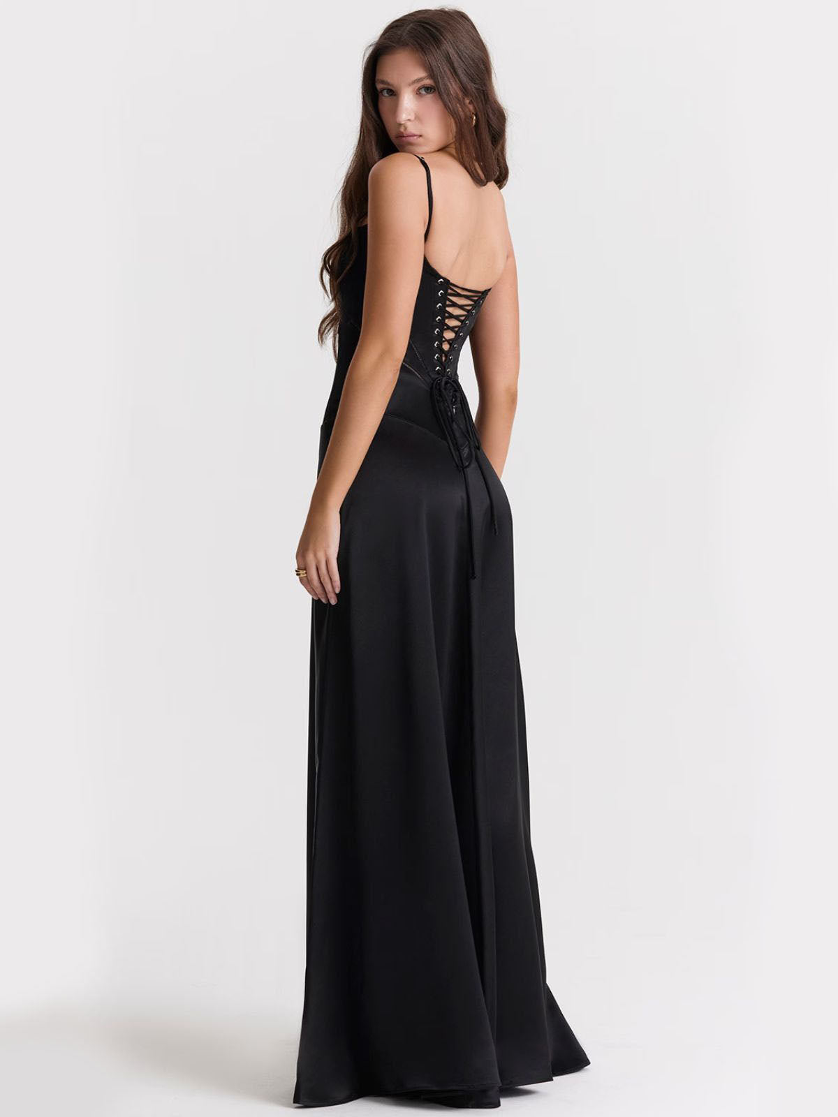 Ophelia black backless dress ideal for black-tie events, with a flattering silhouette and corset-inspired lace-up back.