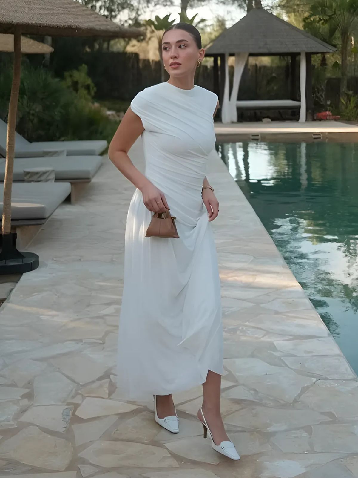 White asymmetrical bodycon maxi dress with pleats, designed for elegant summer parties or formal events.