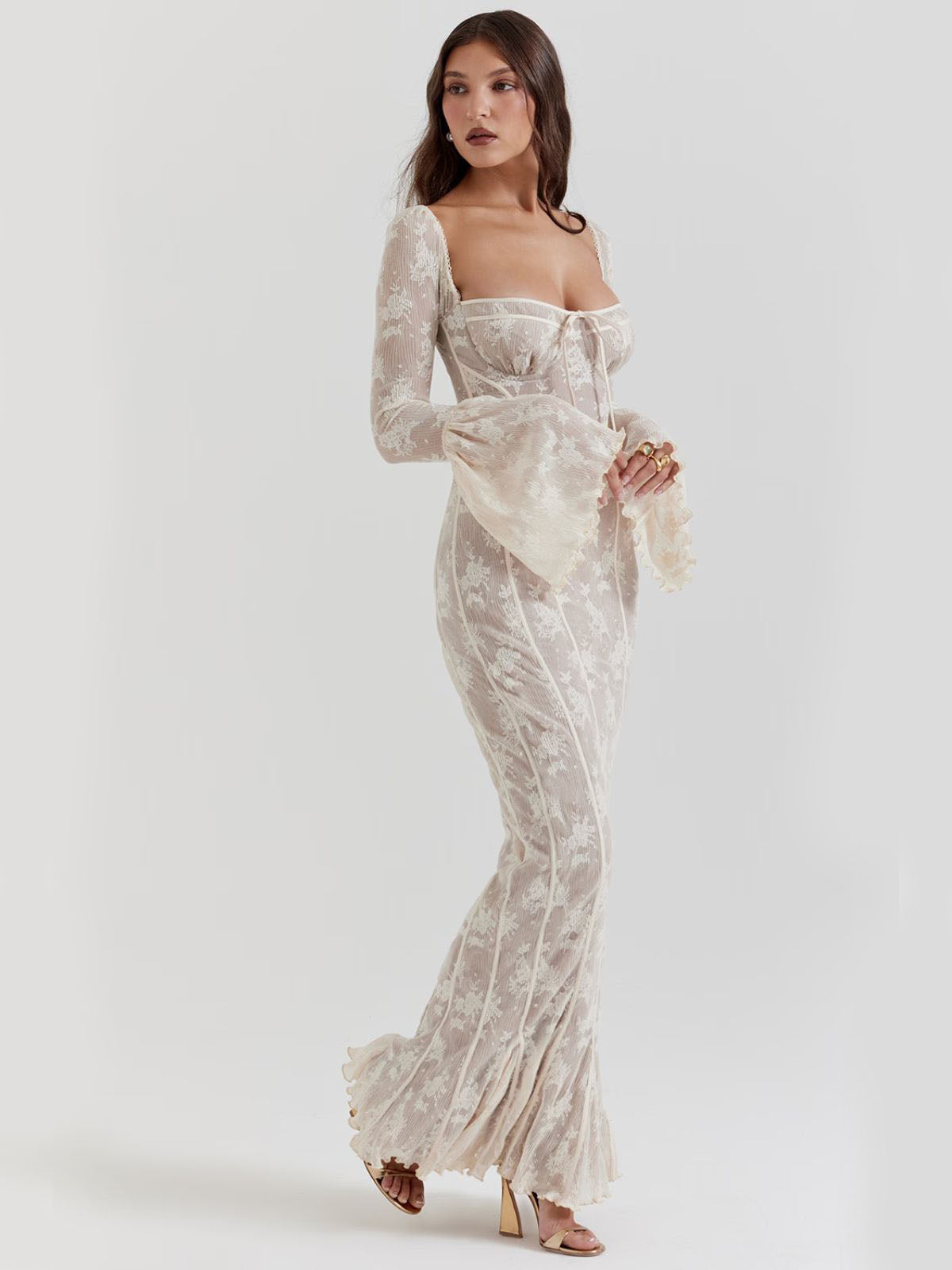 Arabella Long Sleeve Lace Maxi Dress - White, walking pose emphasizing flowing lace fabric, elegant movement, and flared hemline.