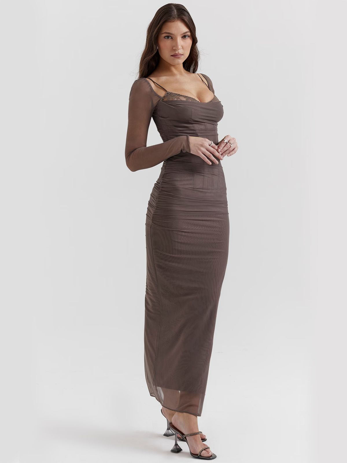Gray lace maxi dress side view with sheer sleeves and a back slit, a modern and elegant eveningwear choice.