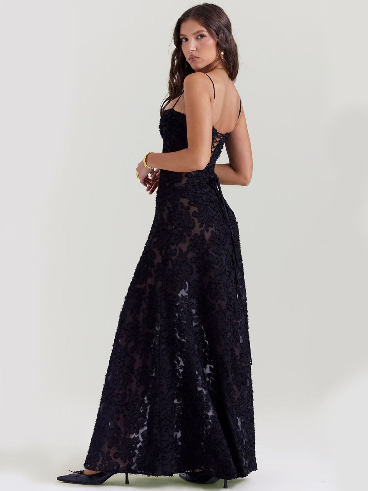 Black floral maxi dress with lace-up back, sheer detailing, and a flattering fit—perfect for evening elegance and special occasions.