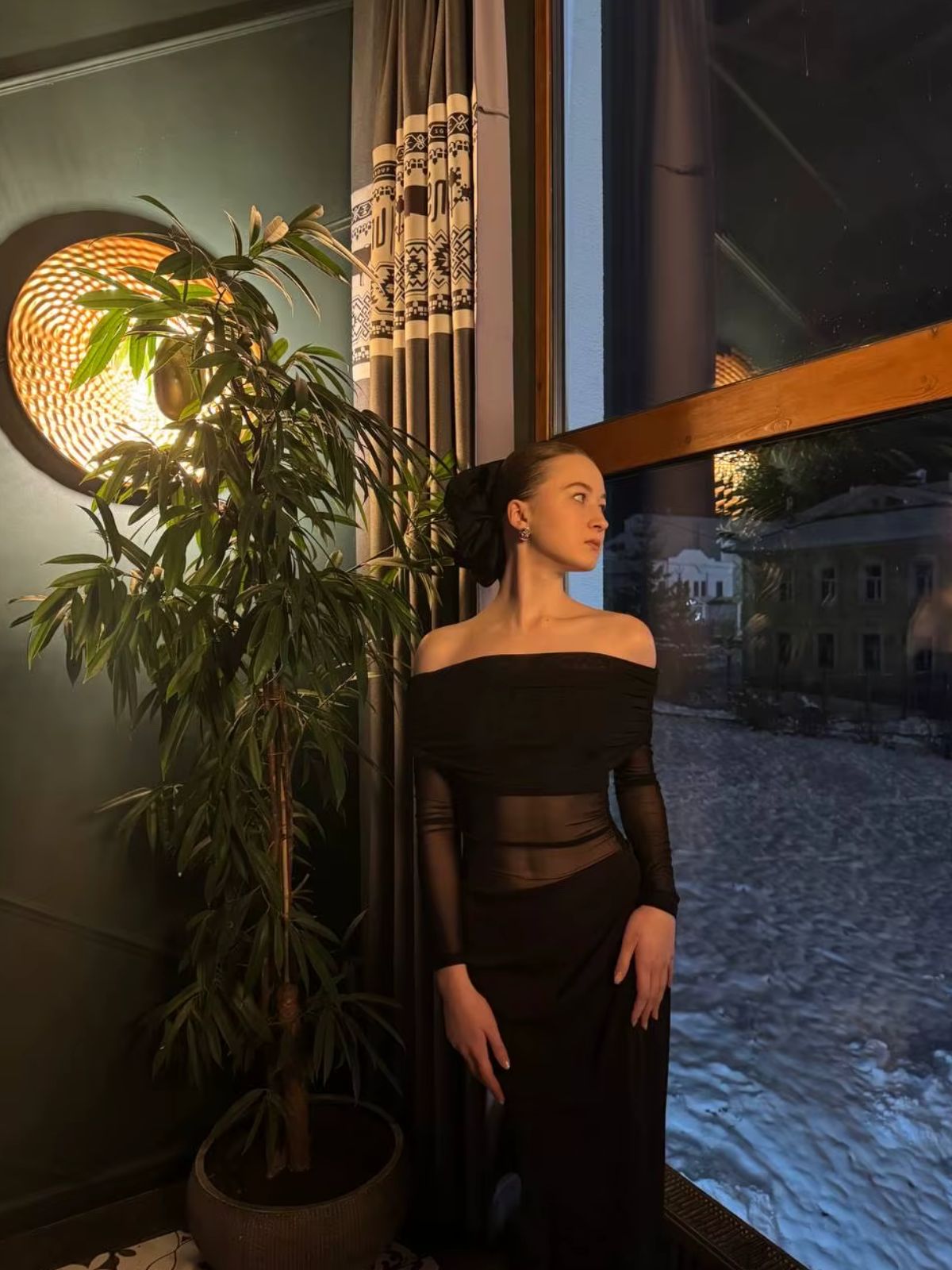 Black Orchid Off-Shoulder Dress with sheer details and high-waist design, ideal for formal and private events.