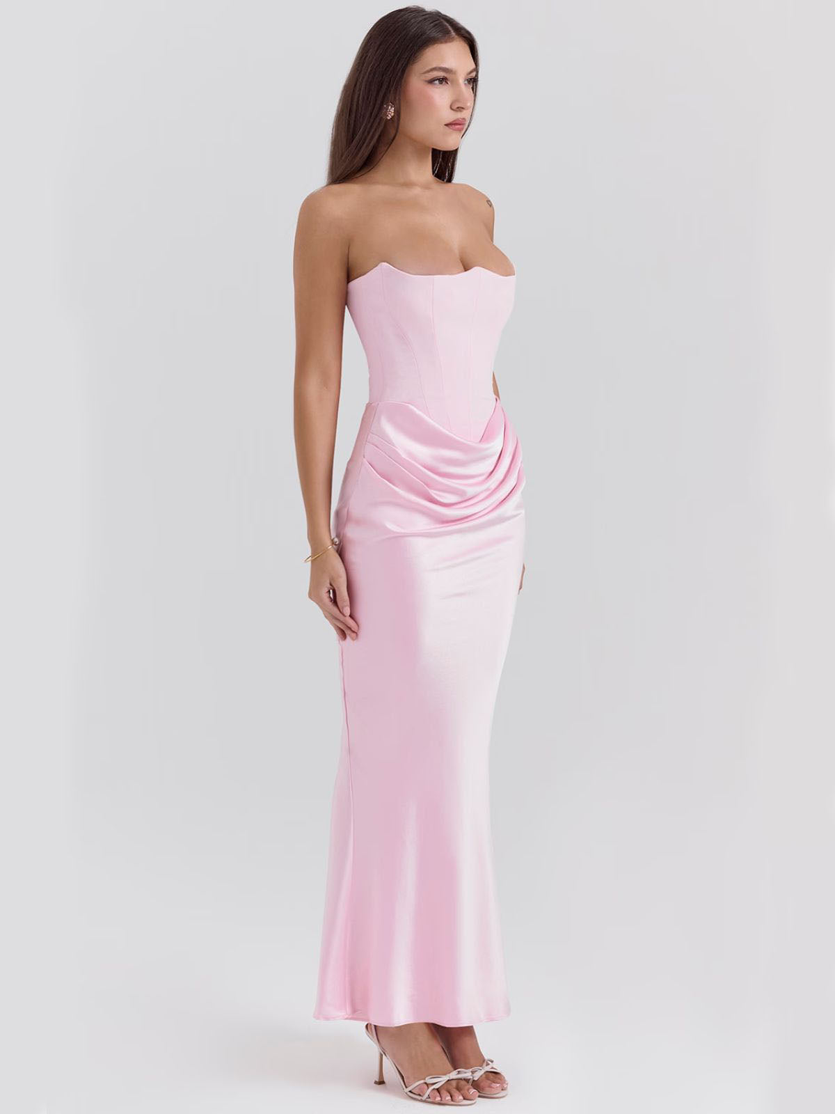 Celestine Corset Maxi Dress - Pink, angled pose showing the luxurious satin draping and structured corset silhouette.