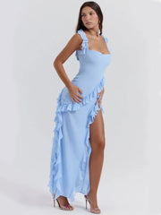 Elysian Ruffle Maxi - Blue side angle with ruffled slit, square neckline, and flowing silhouette. Perfect evening wear.
