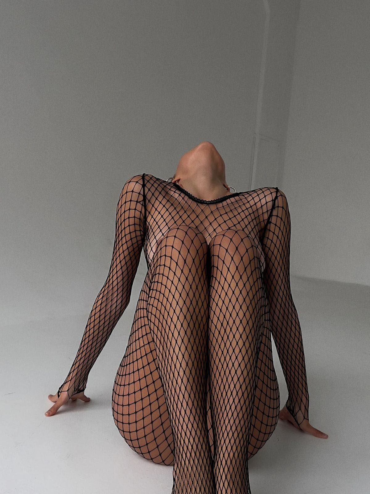 fishnet bodystocking black long sleeve catsuit, front view knees up highlighting diamond fishnet