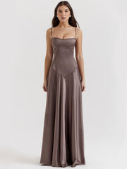 Gray backless dress featuring a flattering corset-inspired fit, draped satin fabric, and an effortless maxi-length skirt.