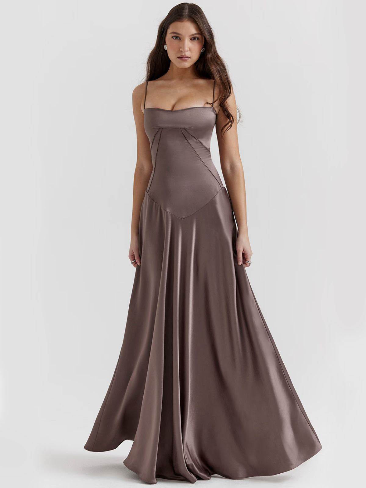 Gray backless dress with delicate spaghetti straps and a flowing silhouette, perfect for black-tie events and formal occasions.