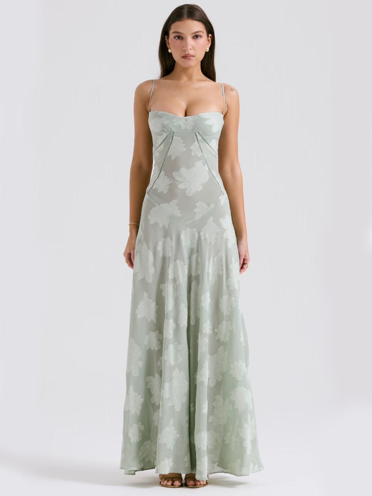Green floral maxi dress featuring a fitted bodice, sweetheart neckline, and flowy skirt for a feminine and elegant look.