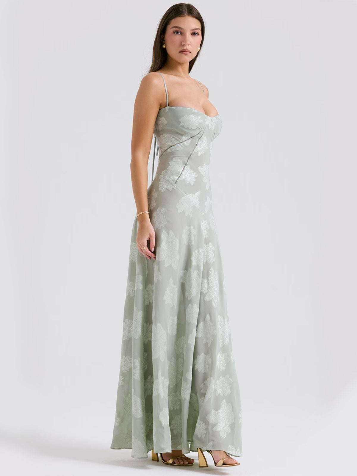 Elegant green floral maxi dress with sheer detailing, a fitted waist, and a flowy skirt—ideal for special occasions.
