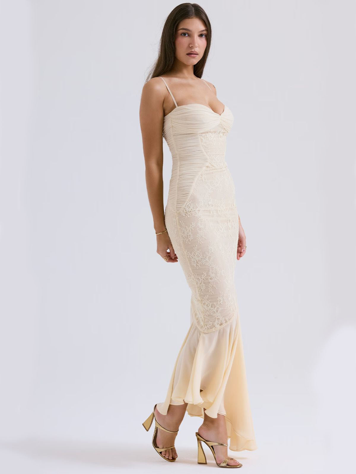 Ivory Grace Lace Gown – floral lace maxi dress with delicate lace, a fitted bodice, and a flowing hem in an elegant side profile.