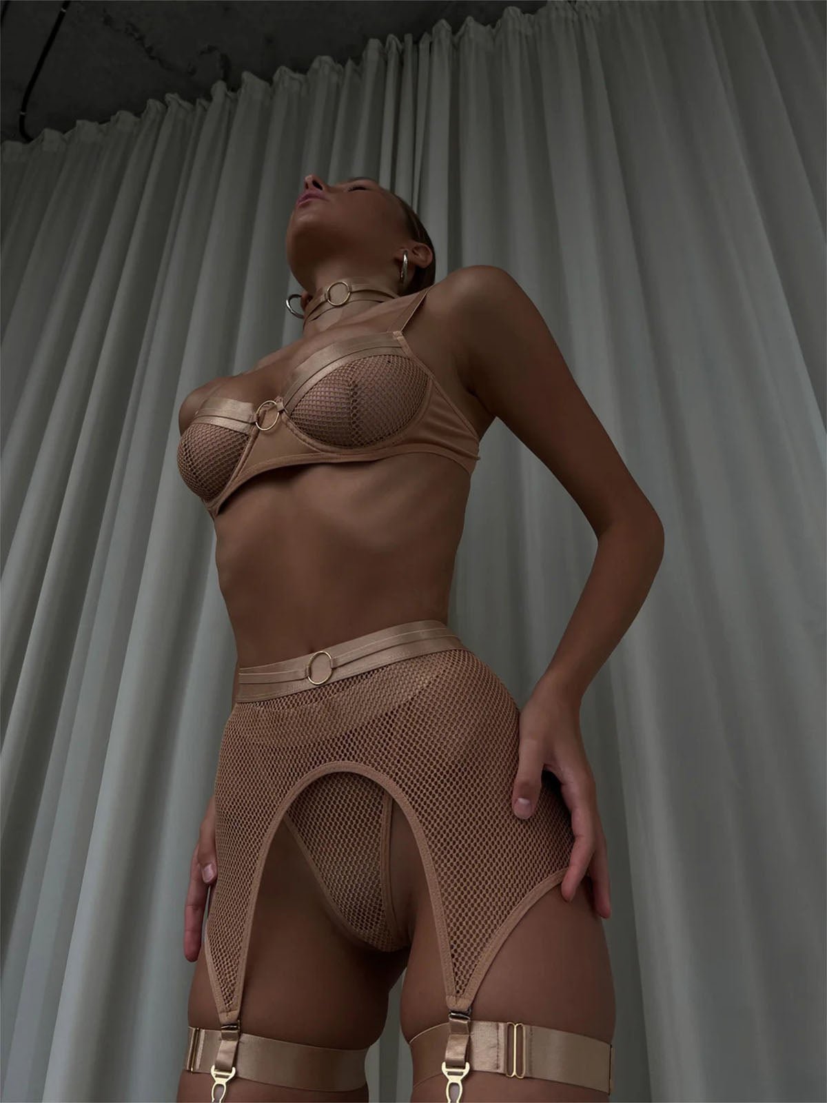 Lingerie Nude Halo Set in nude mesh with leather gloves and choker, bold front pose.