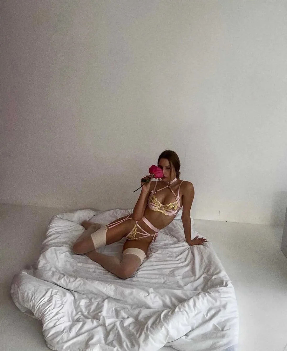 Lingerie Nude Pink Flower full lingerie set shown in elegant soft bedroom pose with garter belt and floral lace.