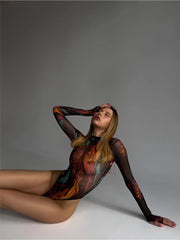 Mesh bodysuit Coffee Swirl tie-dye design, featuring long sleeves in a relaxed sitting pose with sheer fabric.