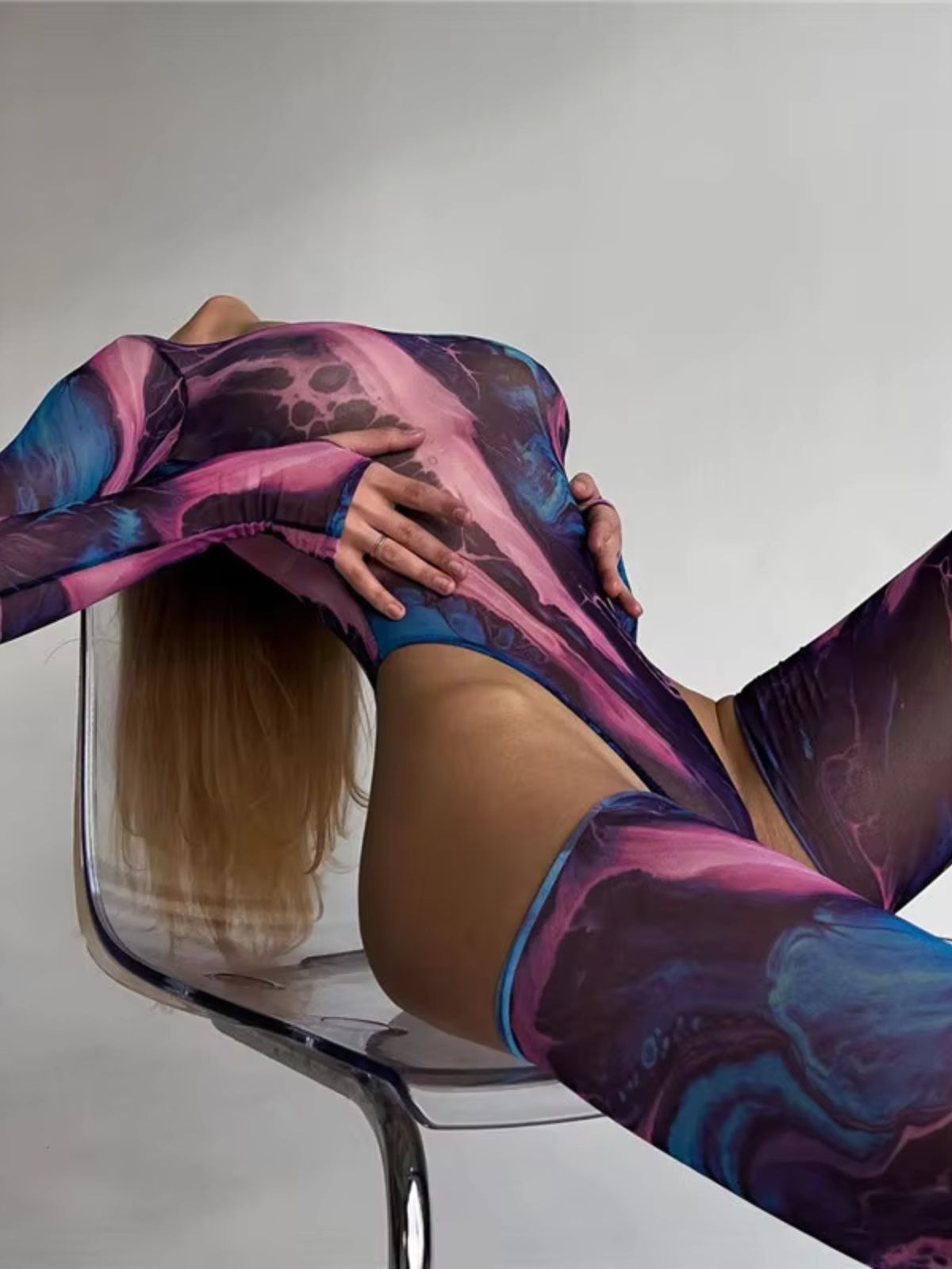 Side view of Purple Haze mesh bodysuit, highlighting its sheer high-cut design and bold tie-dye.