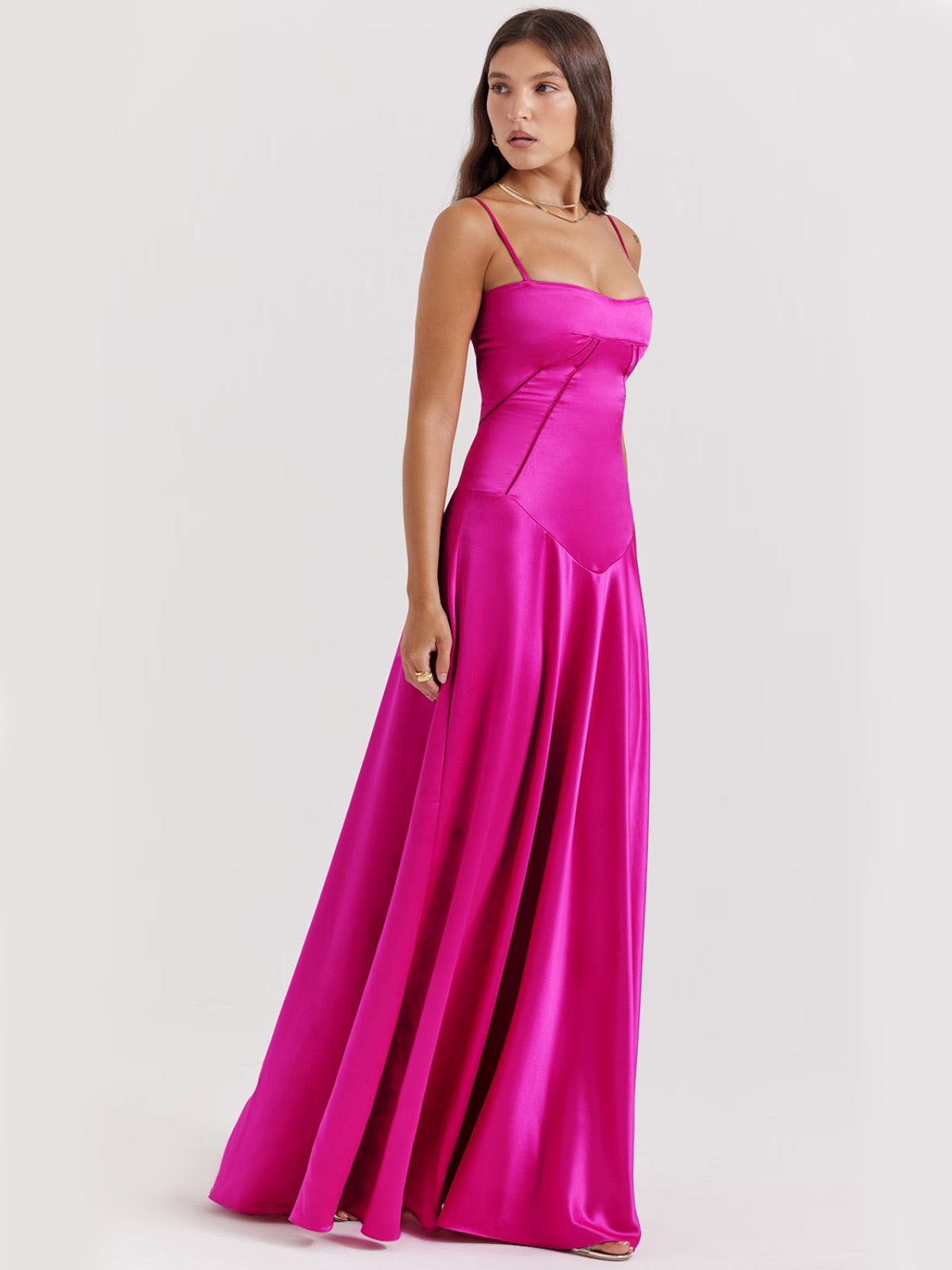 Pink backless dress with adjustable straps, a sculpting bodice, and a long satin skirt for a refined, glamorous look.