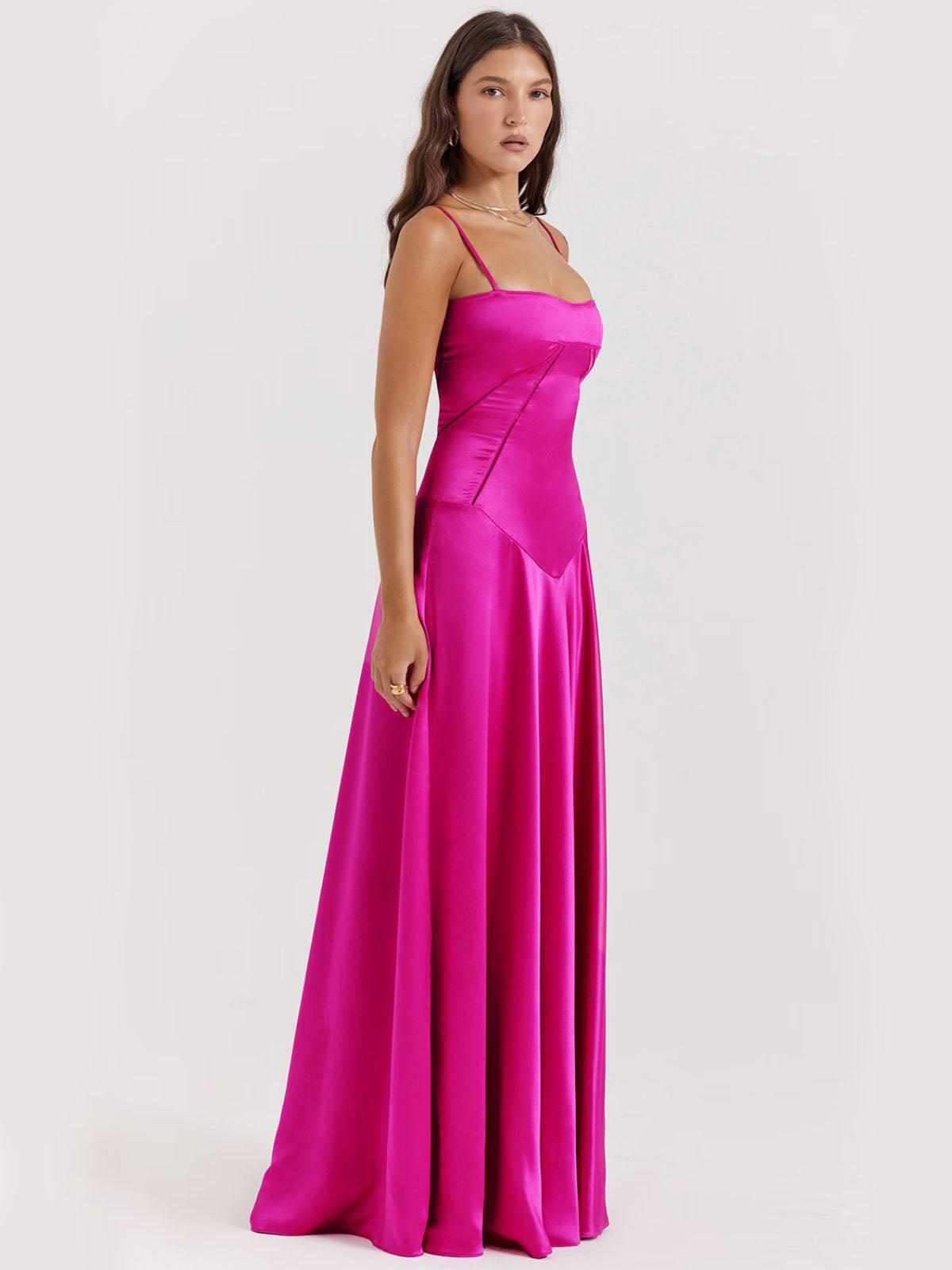 Pink backless dress crafted from silky satin with a flowing skirt and structured bodice, ideal for elegant occasions.