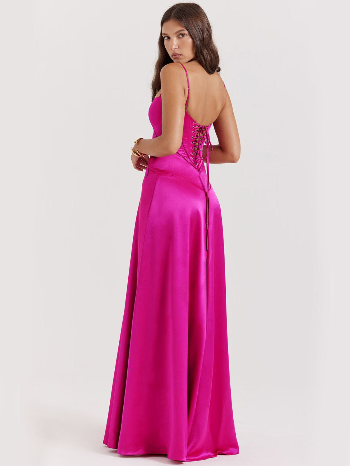Pink backless dress with delicate spaghetti straps and a flowing silhouette, perfect for black-tie events and formal occasions.