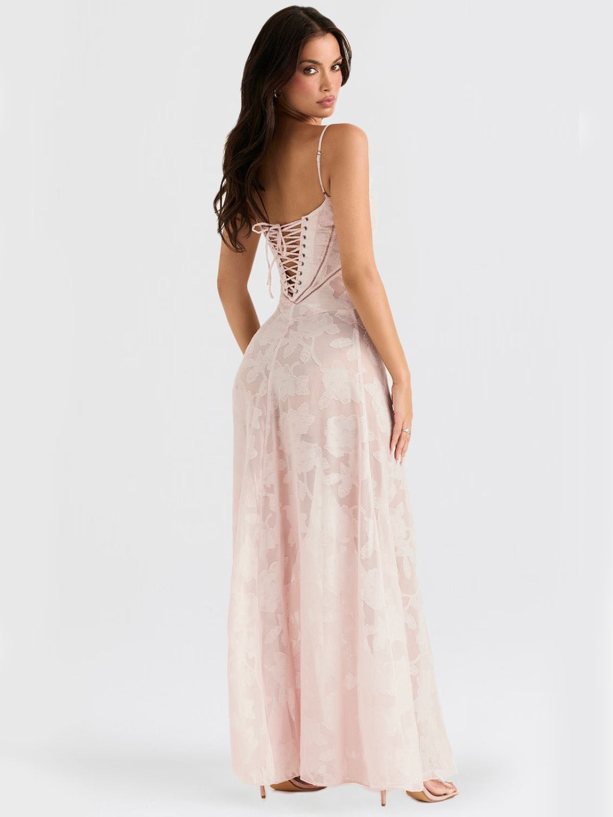 Back view of pink floral maxi dress featuring a stunning lace-up corset and soft floral embroidery.