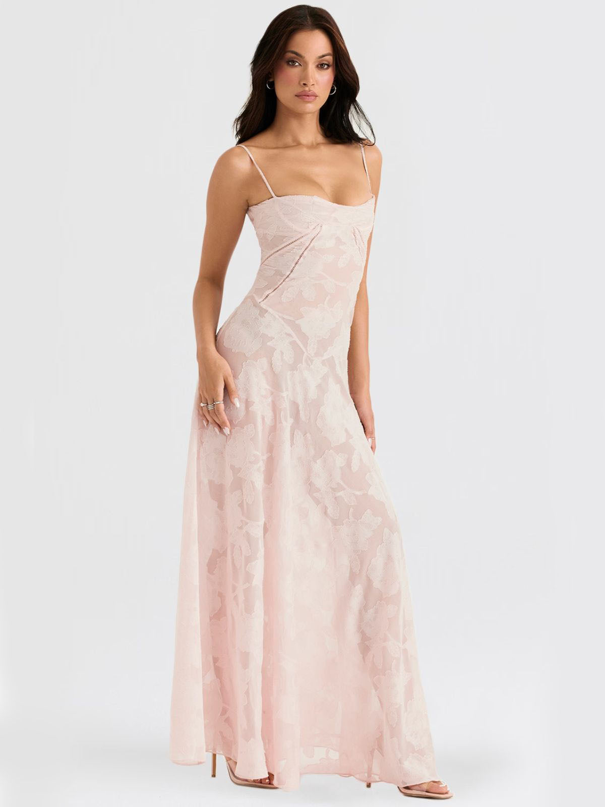 Side view of a pink floral maxi dress showcasing a corset-style lace-up back and delicate floral patterns.