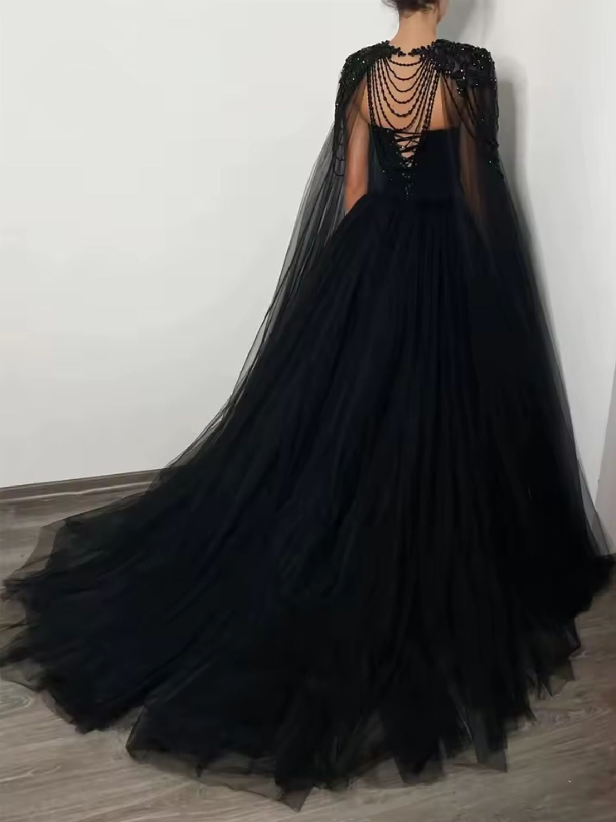 Raven Noir Embellished Wedding Gown back view showcasing flowing tulle drape and cascading beaded details.