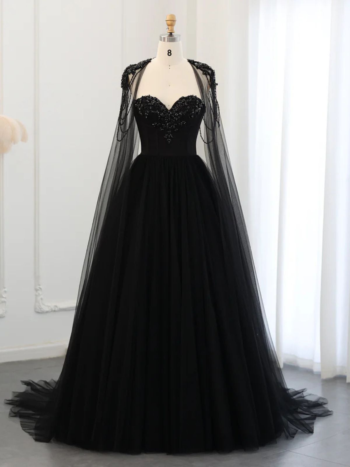 Raven Noir Embellished Wedding Gown displayed on a mannequin, highlighting its luxurious black tulle and beadwork.