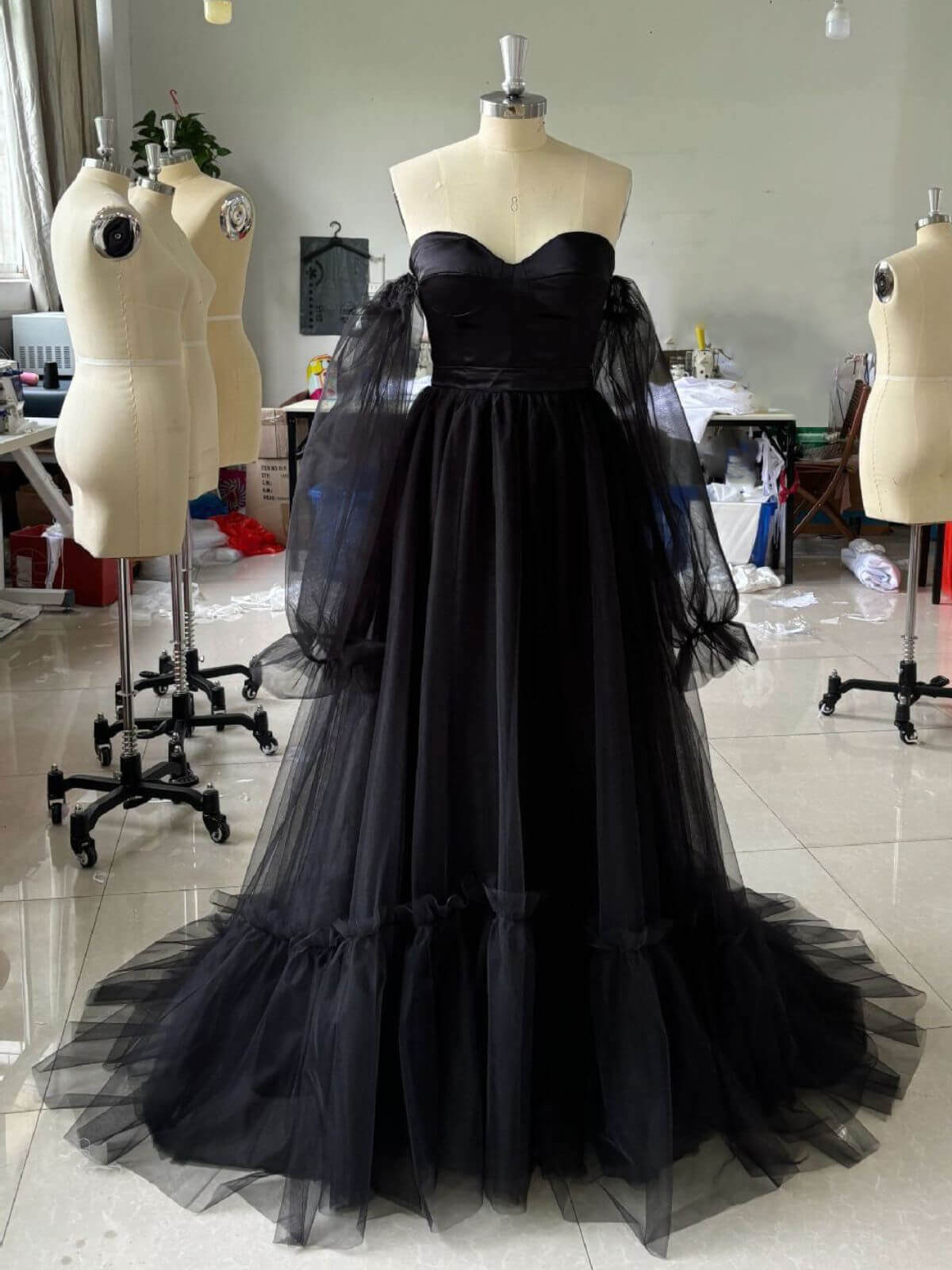 Action shot of romantic tulle black wedding gown with sheer sleeves and elegant movement