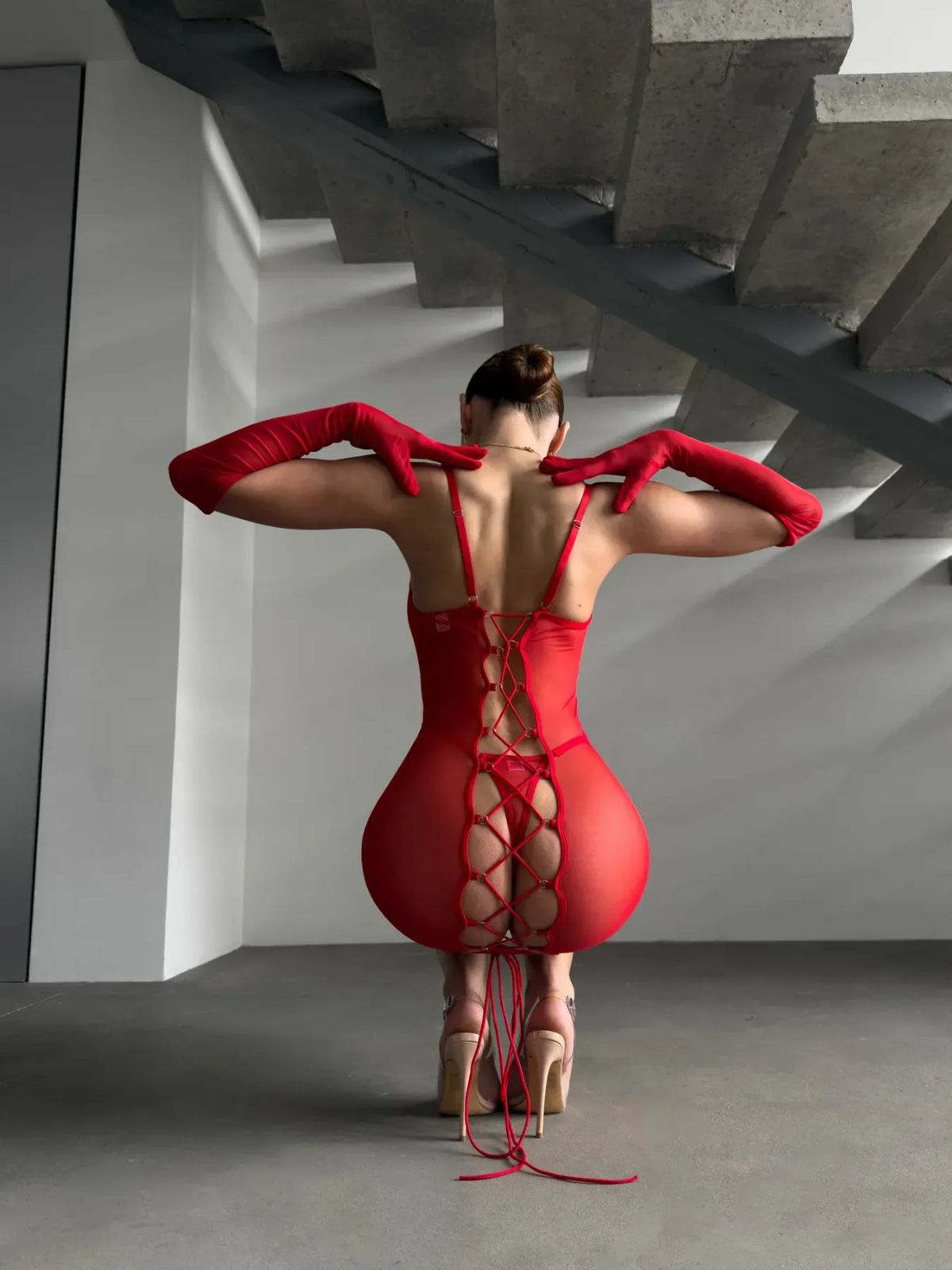 Sheer Lace-Up Bodysuit – Red & Black Mesh back view kneeling pose in red