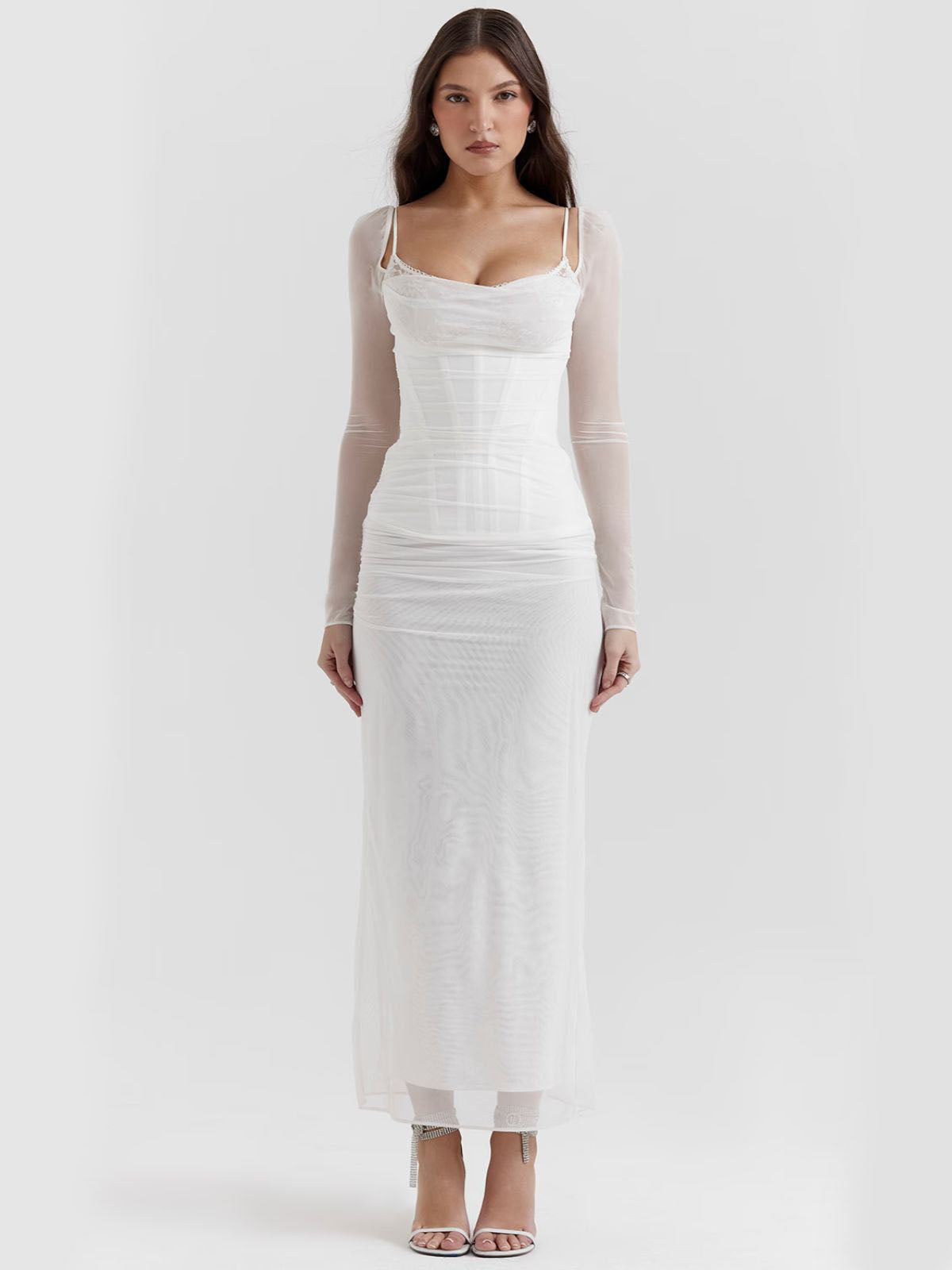 White lace maxi dress with sheer mesh long sleeves and a stunning neckline, ideal for special occasions.